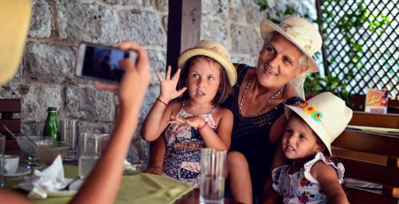 taking picture of grandmother and girls