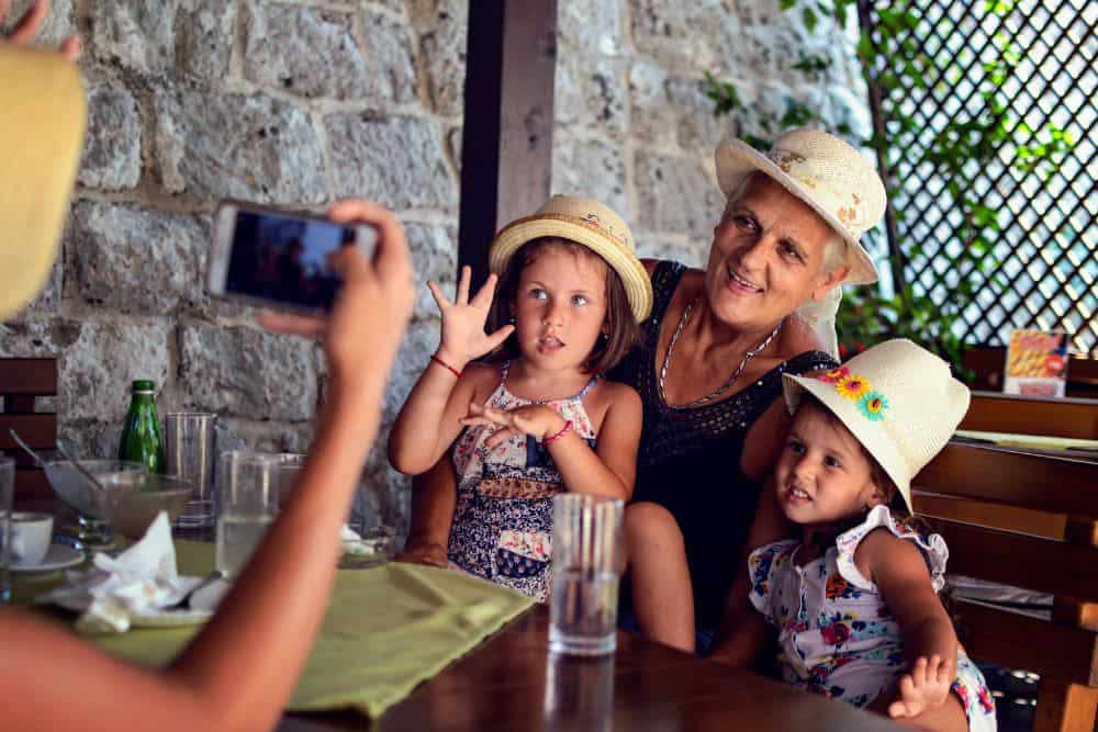 taking picture of grandmother and girls