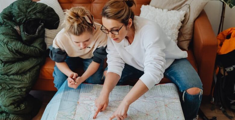 mother and teen girl looking at map