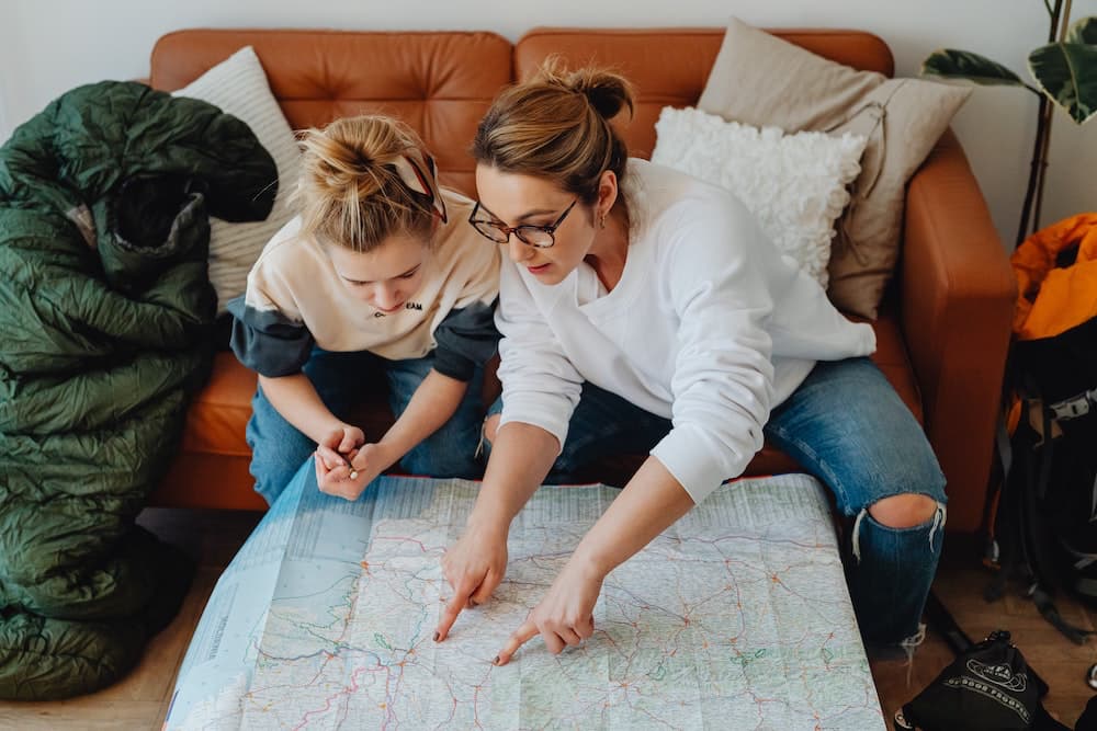 mother and teen girl looking at map