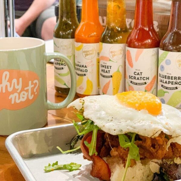 open faced egg sandwich on tray with coffee mug