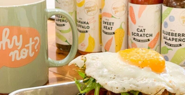 open faced egg sandwich on tray with coffee mug