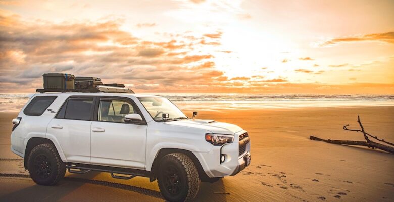 Toyota 4Runner on beach with car roof rack basket