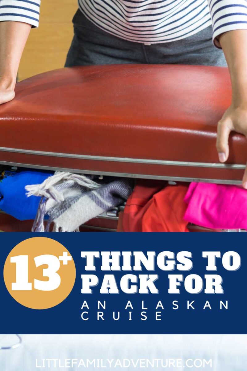 overflowing suitcase with scarves and sweaters for alaska cruise
