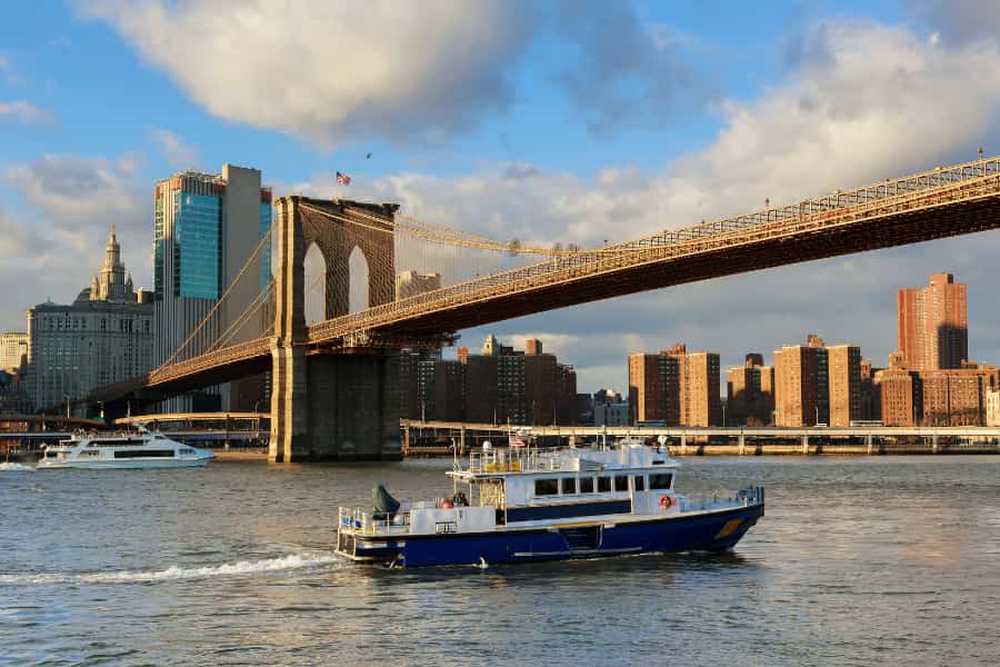Boat cruises under Brooklyn Brudge - NYC