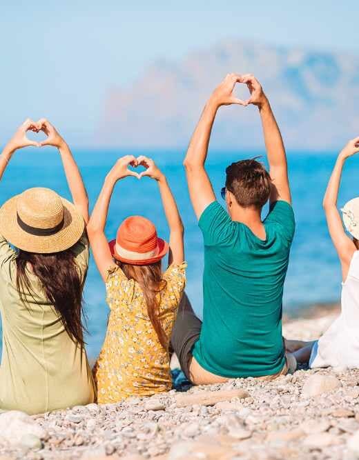 family love languages on the beach with hands in shape of hearts