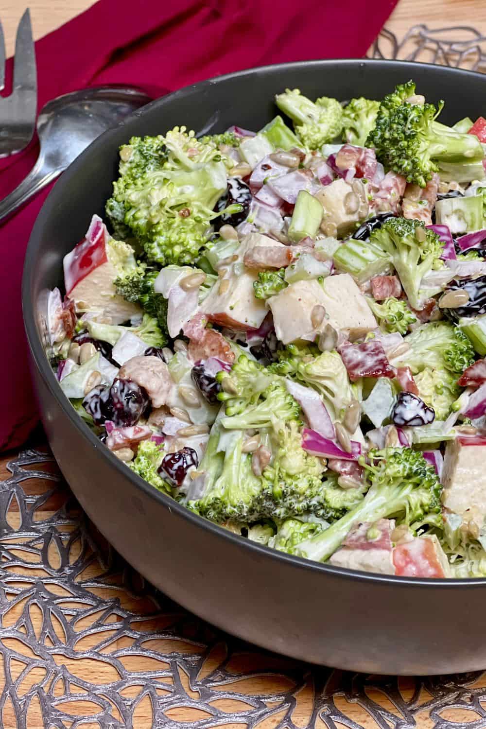 chopped broccoli craisin salad in a bowl with napkin