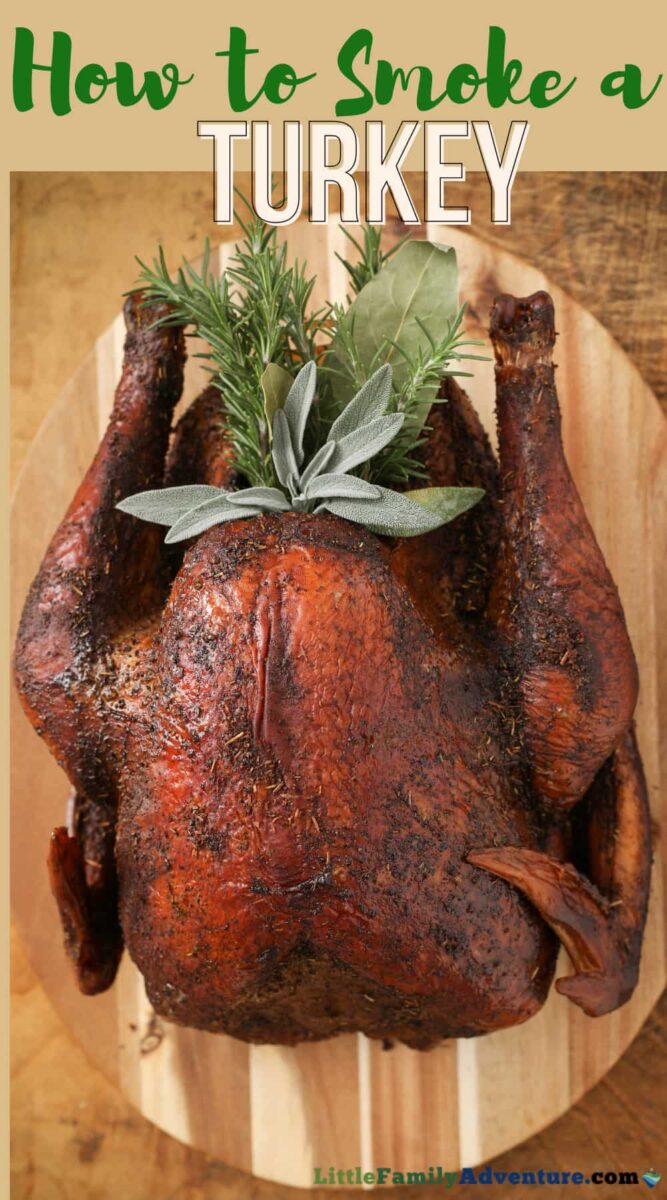 smoked turkey with sage and herbs on a wooden platter