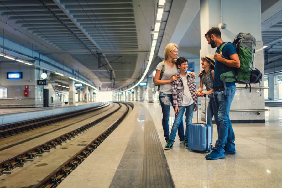 family backpacking at train station