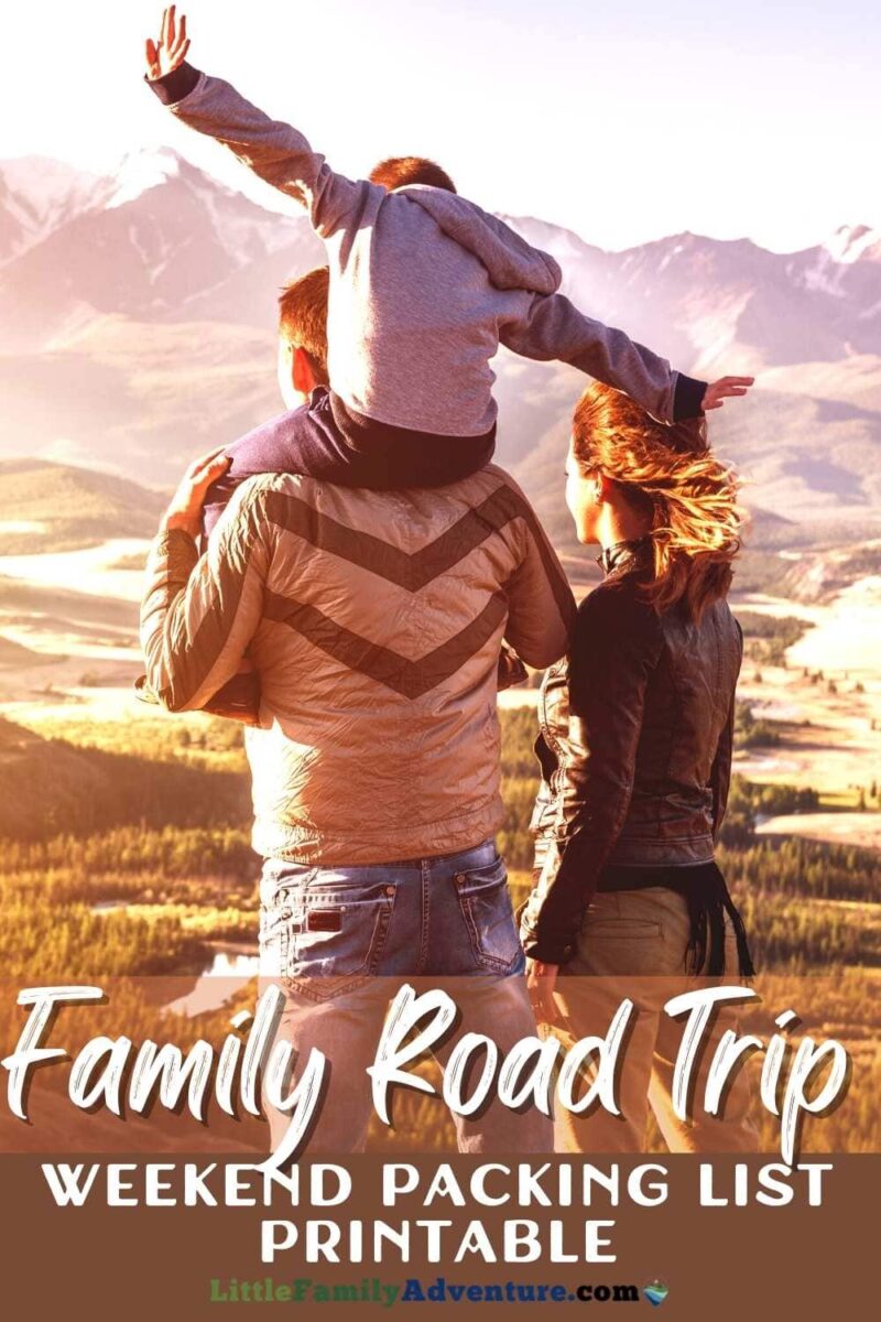 family looking at landscape on road trip in the sunset