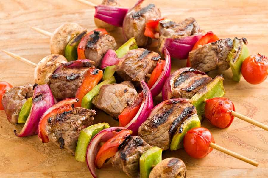 grilled shish kebabs with vegetables on bamboo skewers