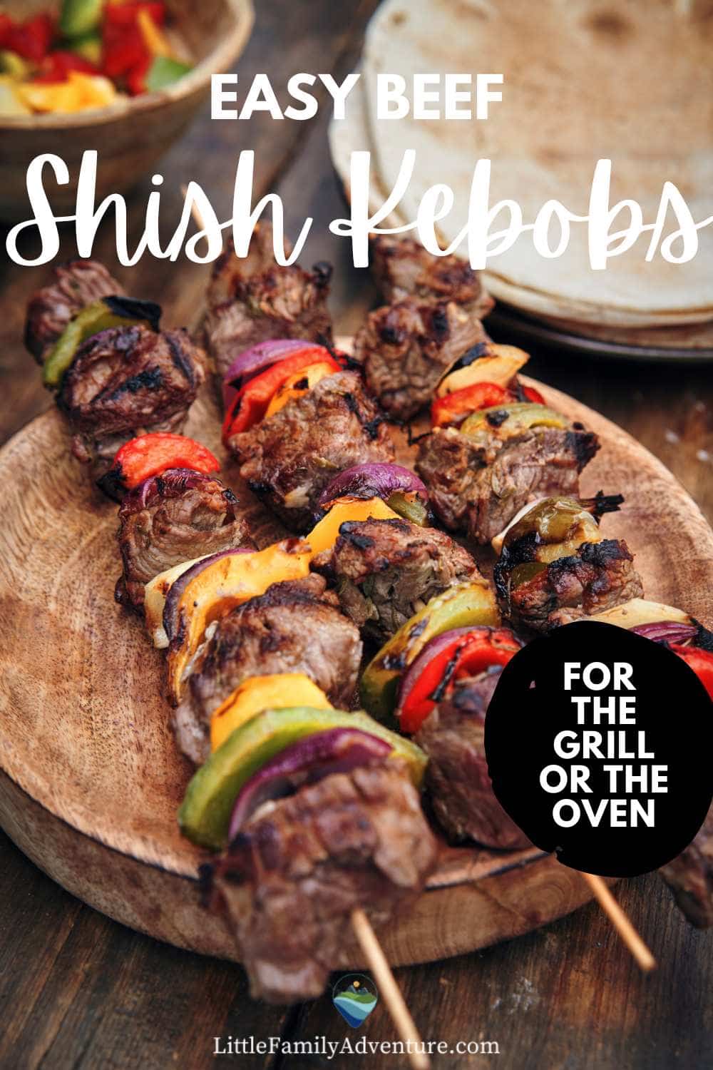 meat and vegetable beef shish kabobs on a wooden platter
