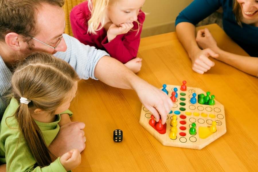 family playing board game for fun winter activity