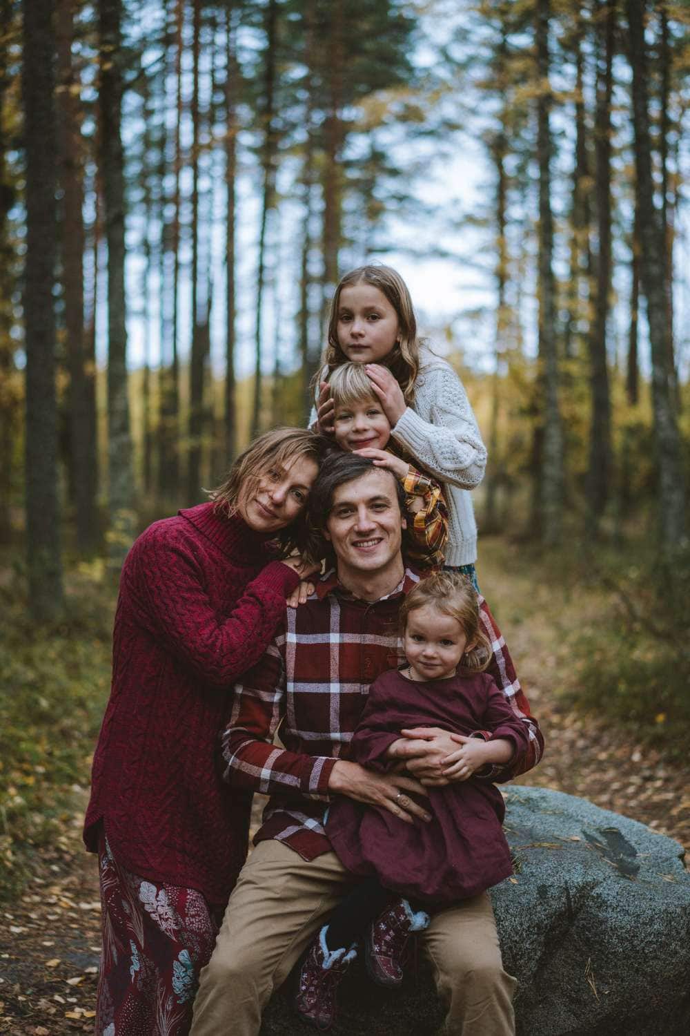 family fin matching shirts in woods for family photo shoot