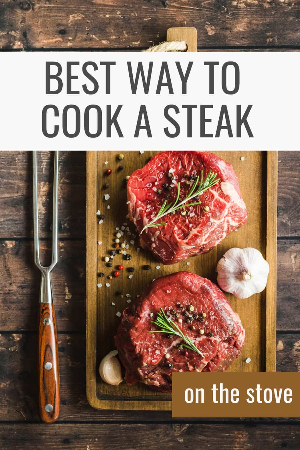 raw steak with rosemary and garlic on cutting board