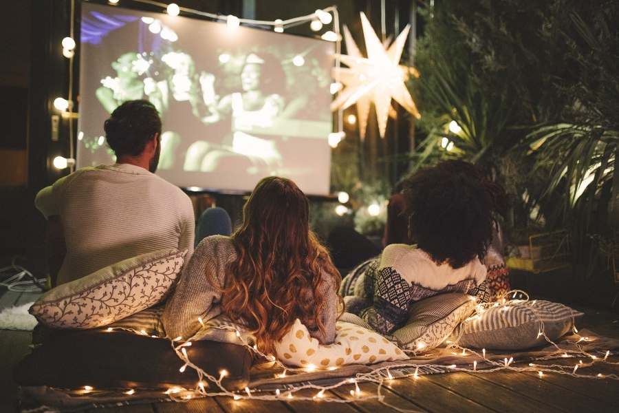 families watching holiday movie on projector