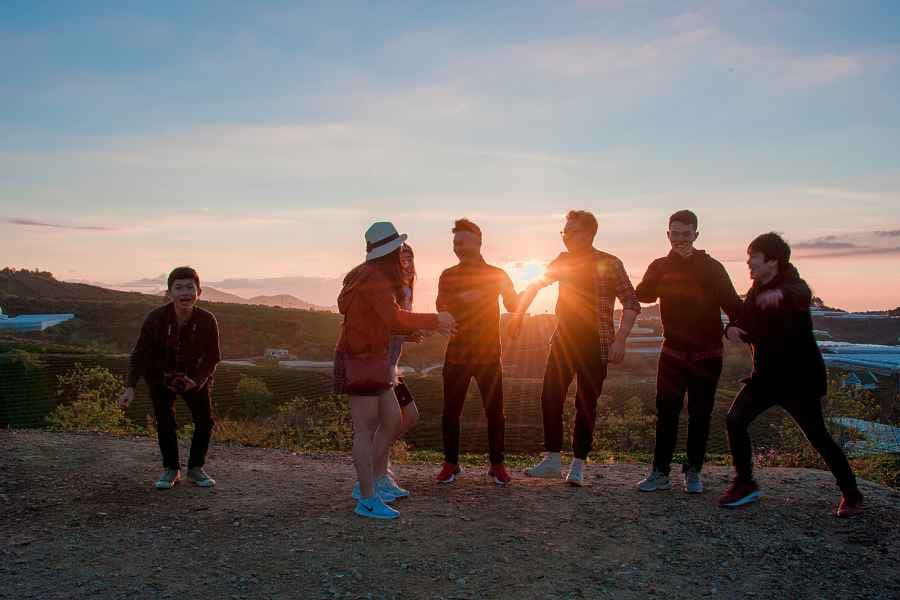 group of teenagers on a sunset hike