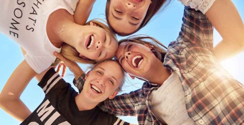 group of teens in a circle smiling