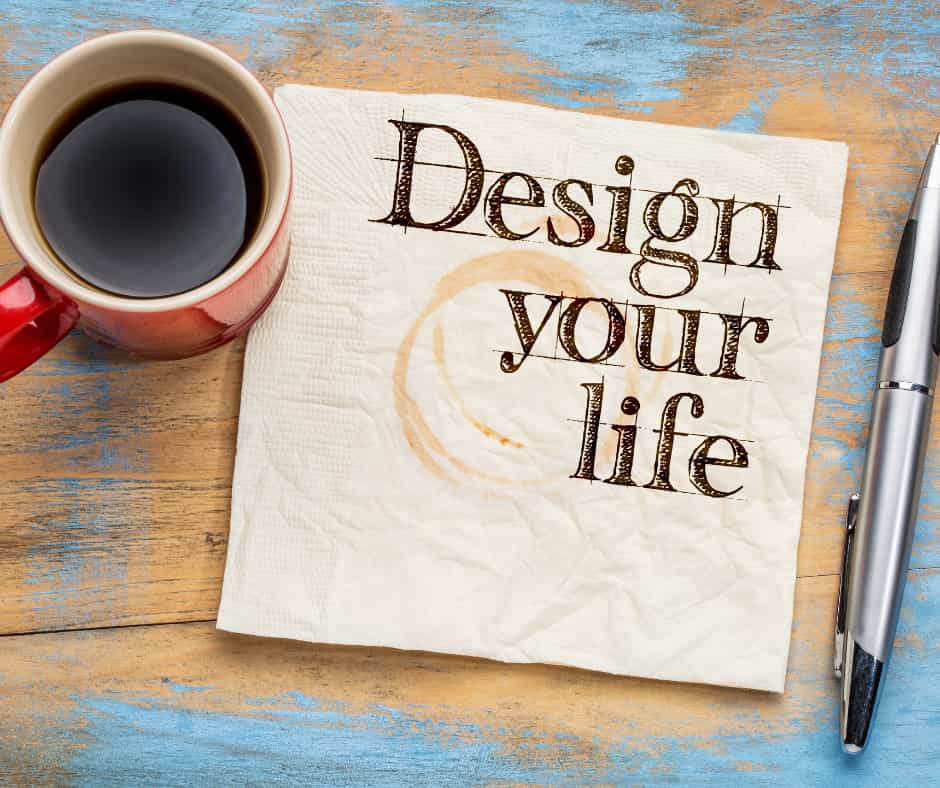 coffee cup on paper with coffee stain that says design your life