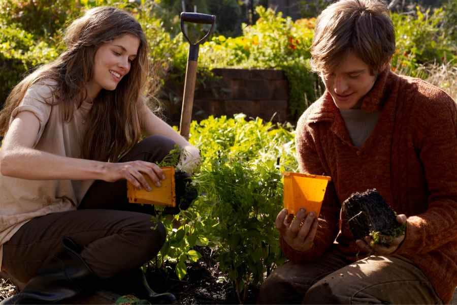 teen girl and boy starting a garden at home backyard