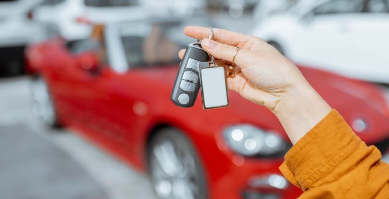 car rental keys in front of convertible