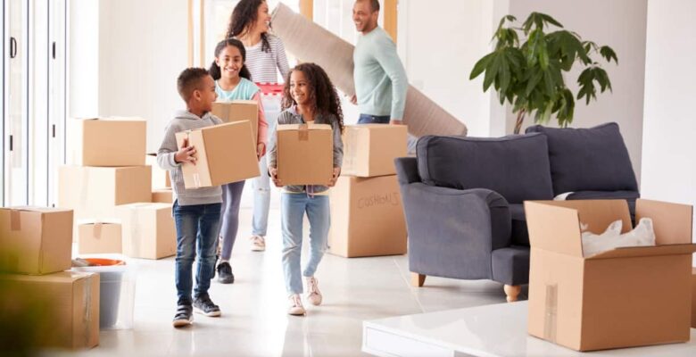 family holding moving boxes