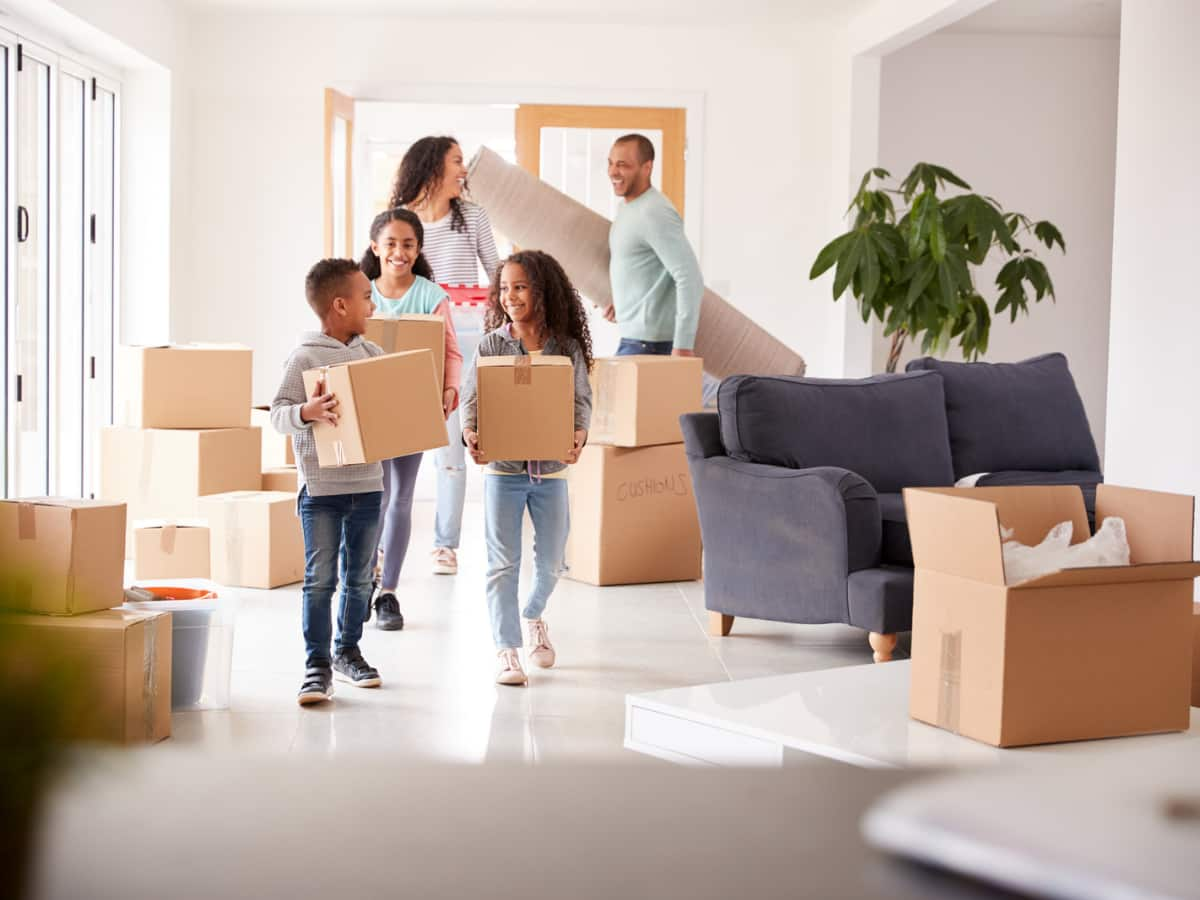 family holding moving boxes