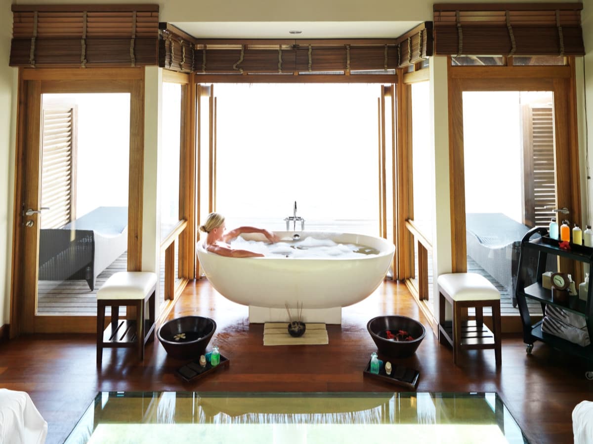 woman relaxing in tub in resort room
