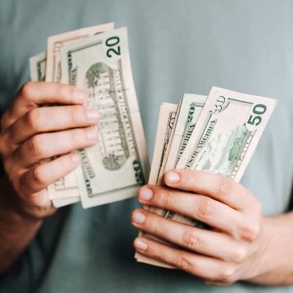 male holding dollar bills