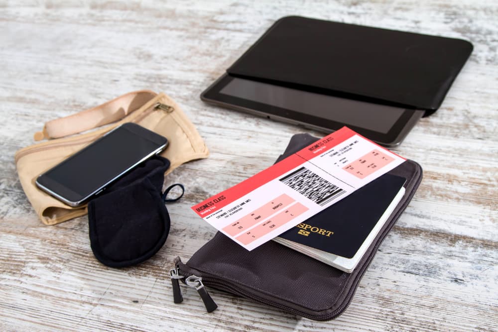 airline tickets and passports with travel items on table