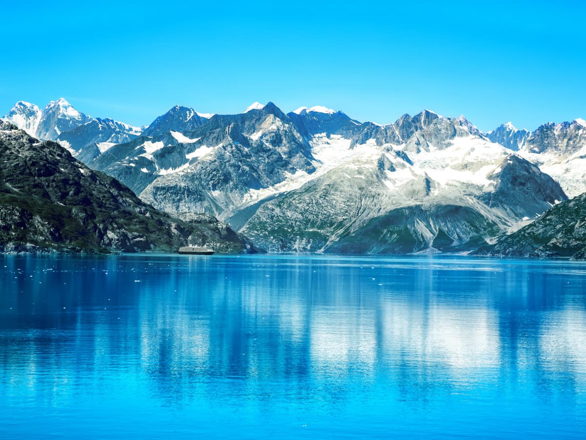 Cruise ship in Alaskan waters in front of mountains