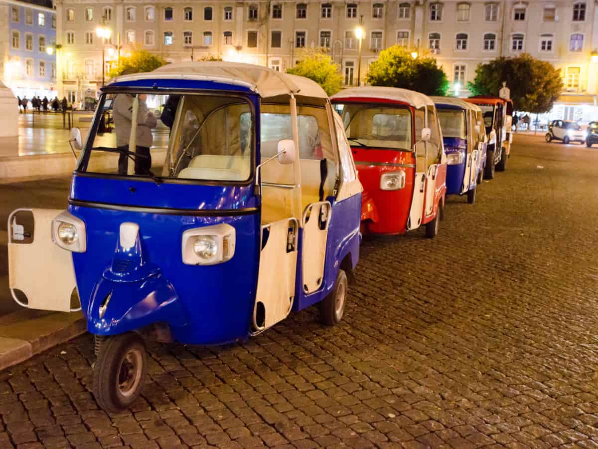 four tuk tuk on the street at night