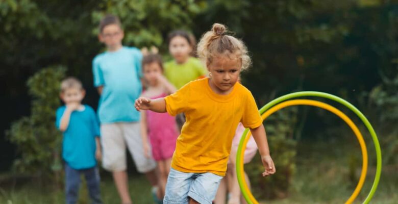 children running backyard obstacle course