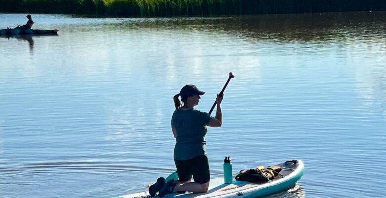 woman paddling BOTE paddleboard on lake
