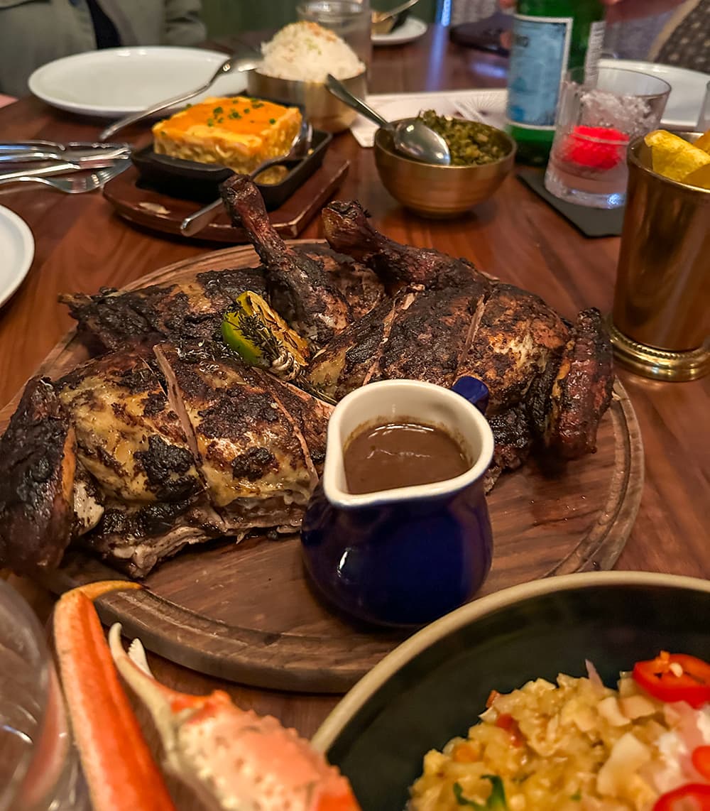 Jerk Chicken on a platter with chicken jus