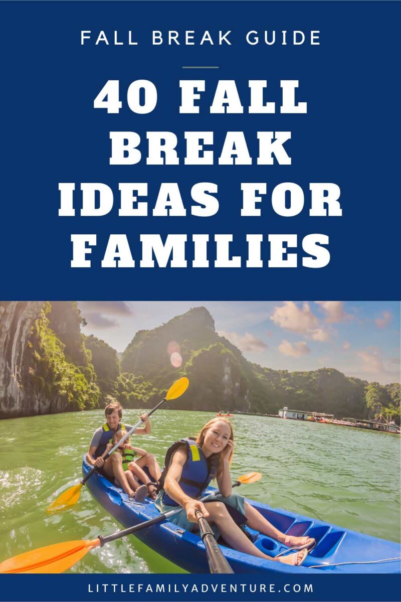 family in kayak on river with mountains in background