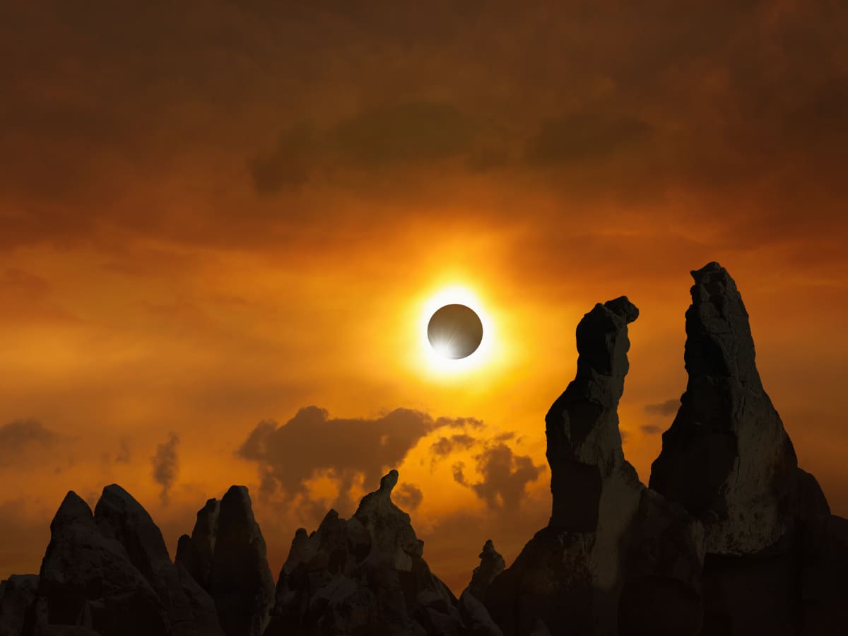solar eclipse over mountains