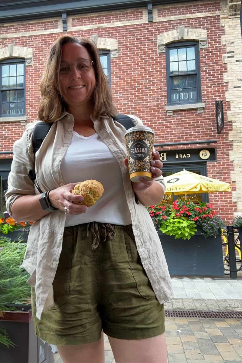 Woman with sconce and coffee in hand from Balzar's Coffee in Toronto