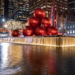 Fountain Square with large red christmass tree balls in water