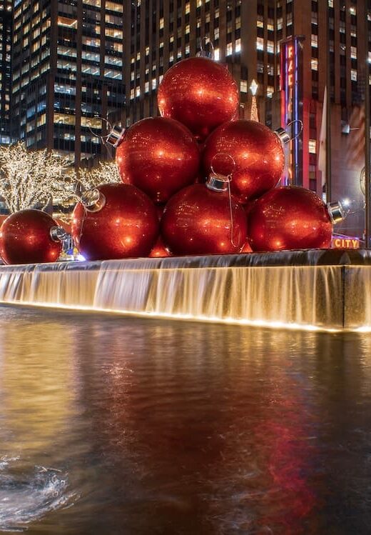 Fountain Square with large red christmass tree balls in water