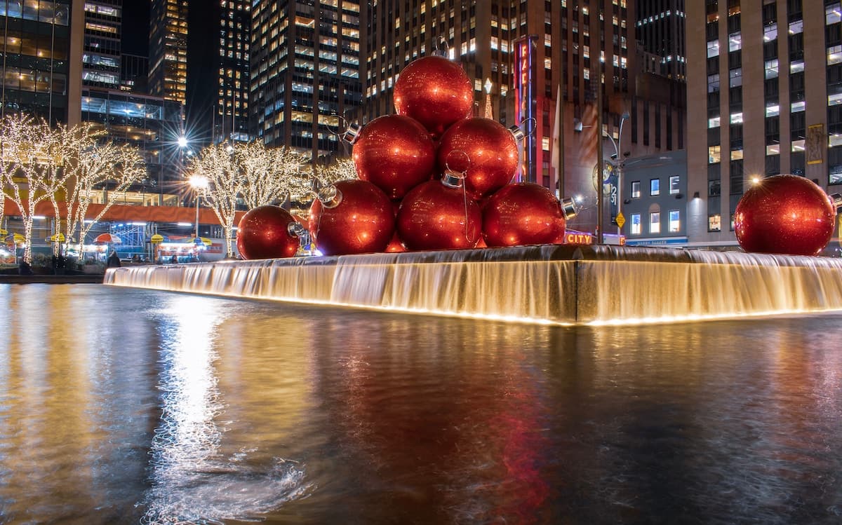 Fountain Square with large red christmass tree balls in water