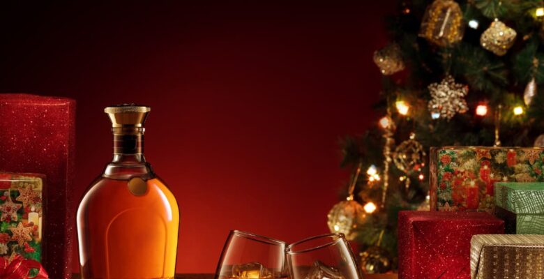 whiskey and glasses near the christmas with gifts