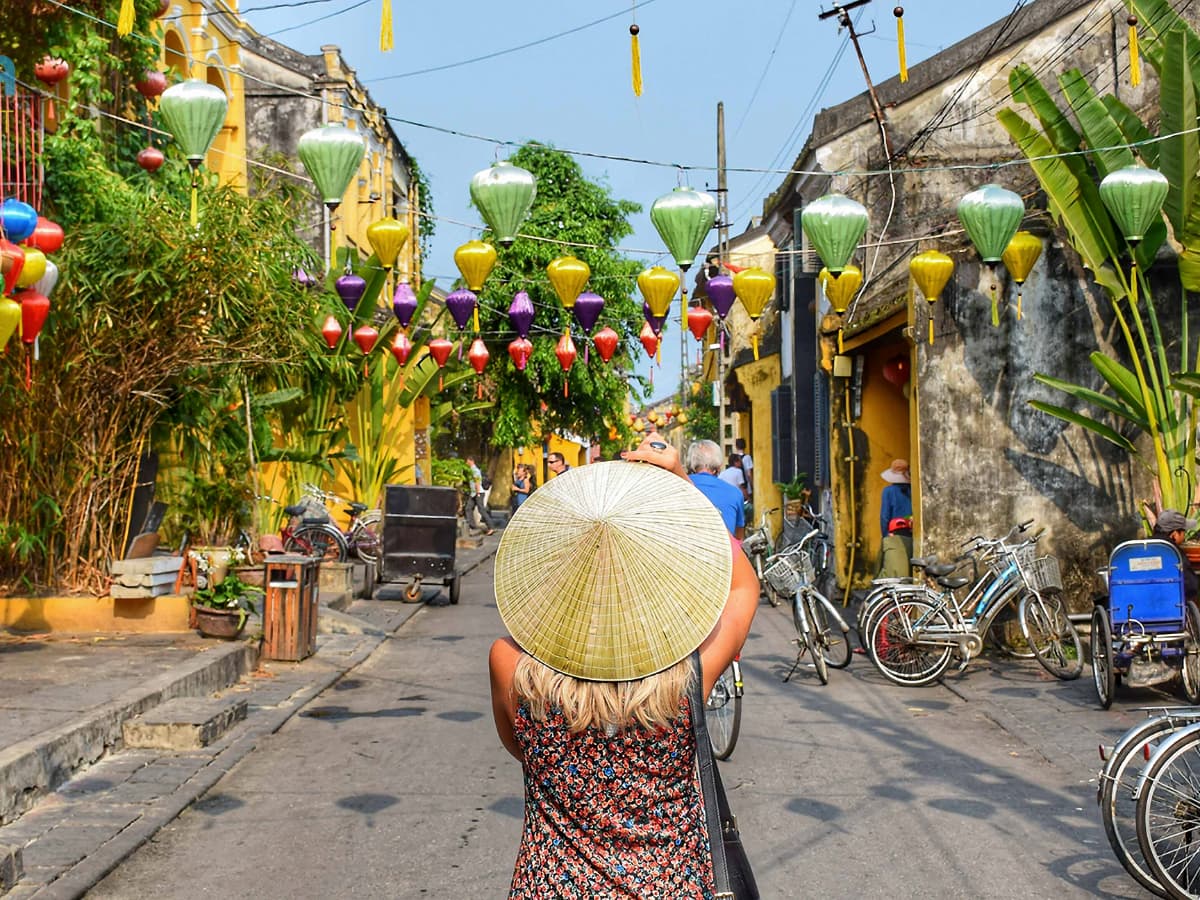 places to see in Vietnam - woman in middle of street wearing a hat