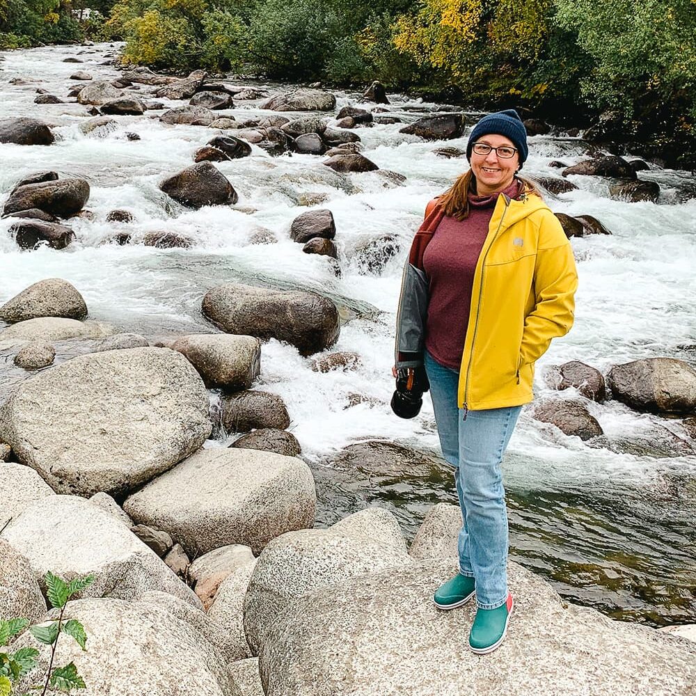 woman standing by creek in Palmer Alaska
