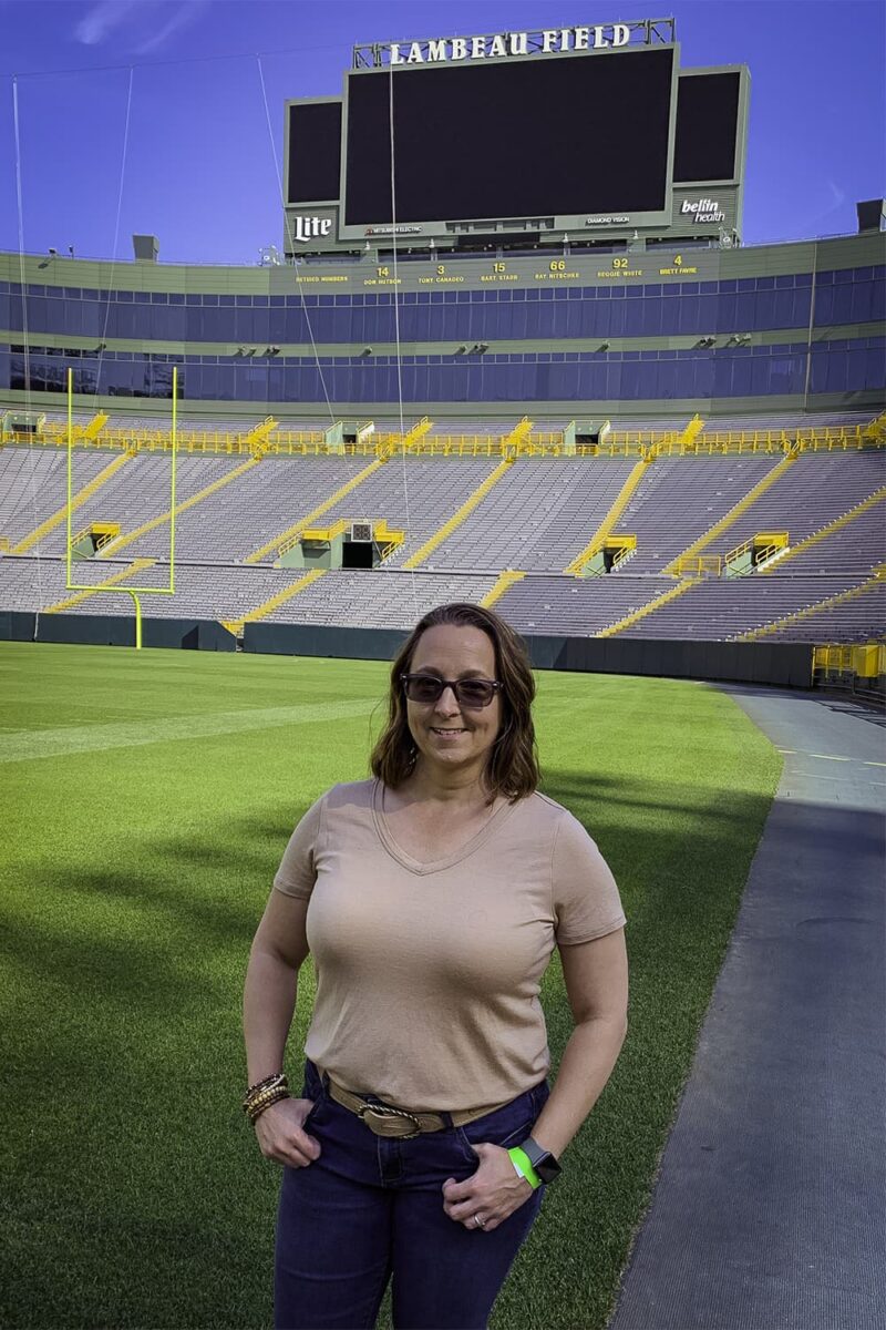 woman standing in front on Lambeau Field 
