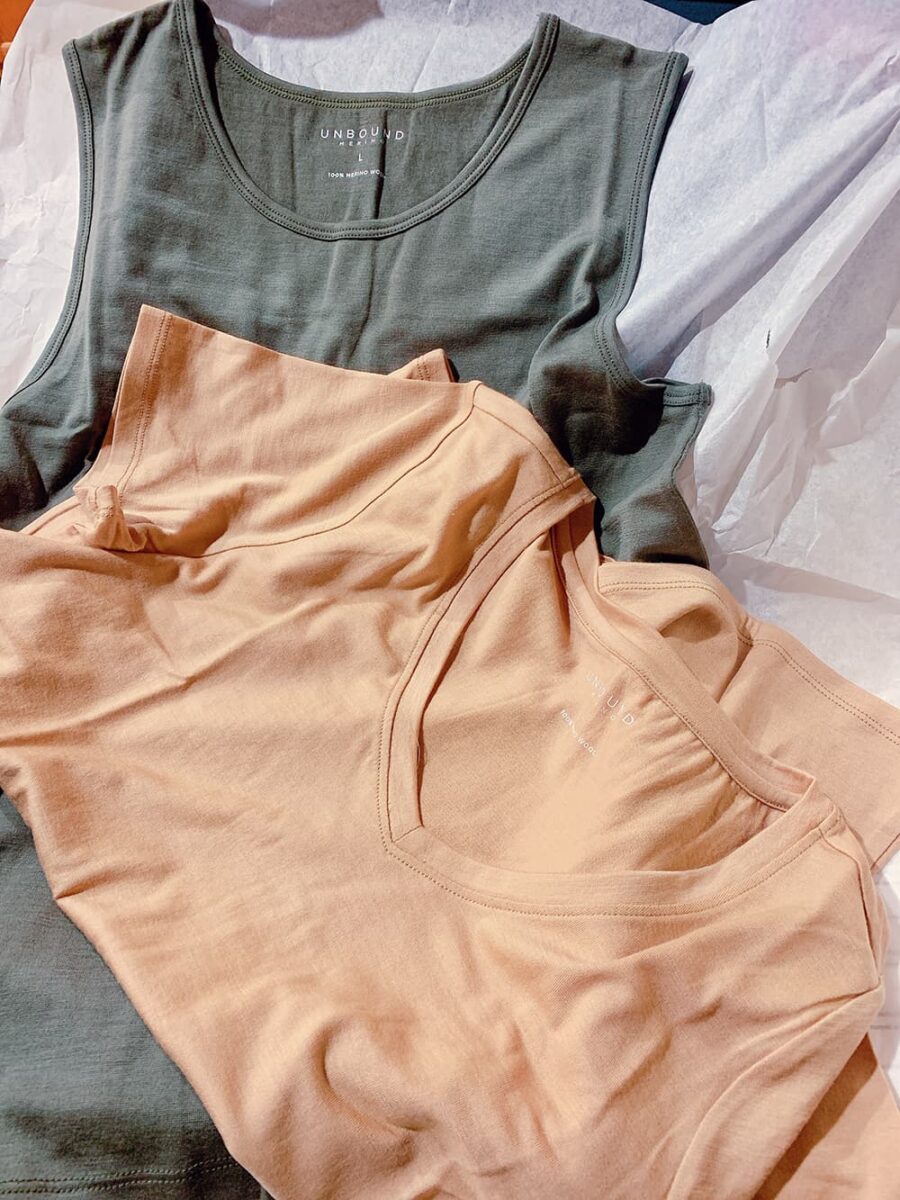 Unbound Merino tee shirt and muscle tank flat lay