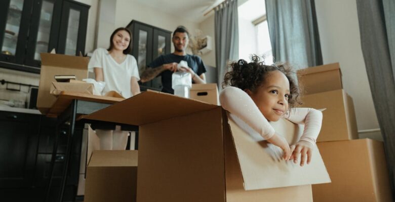 family moving - room with boxes and a girl inside one