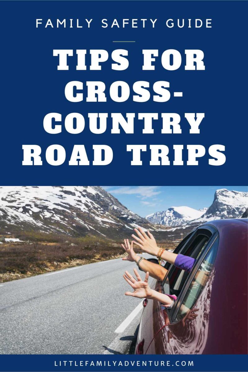 family on cross-country road trip with hands sticking out of car windows and mountains in background