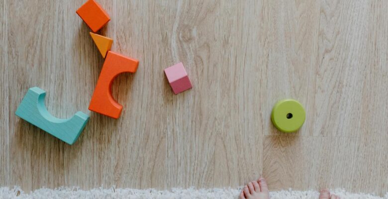 kid friendly space - toddler feet and blocks on a floor