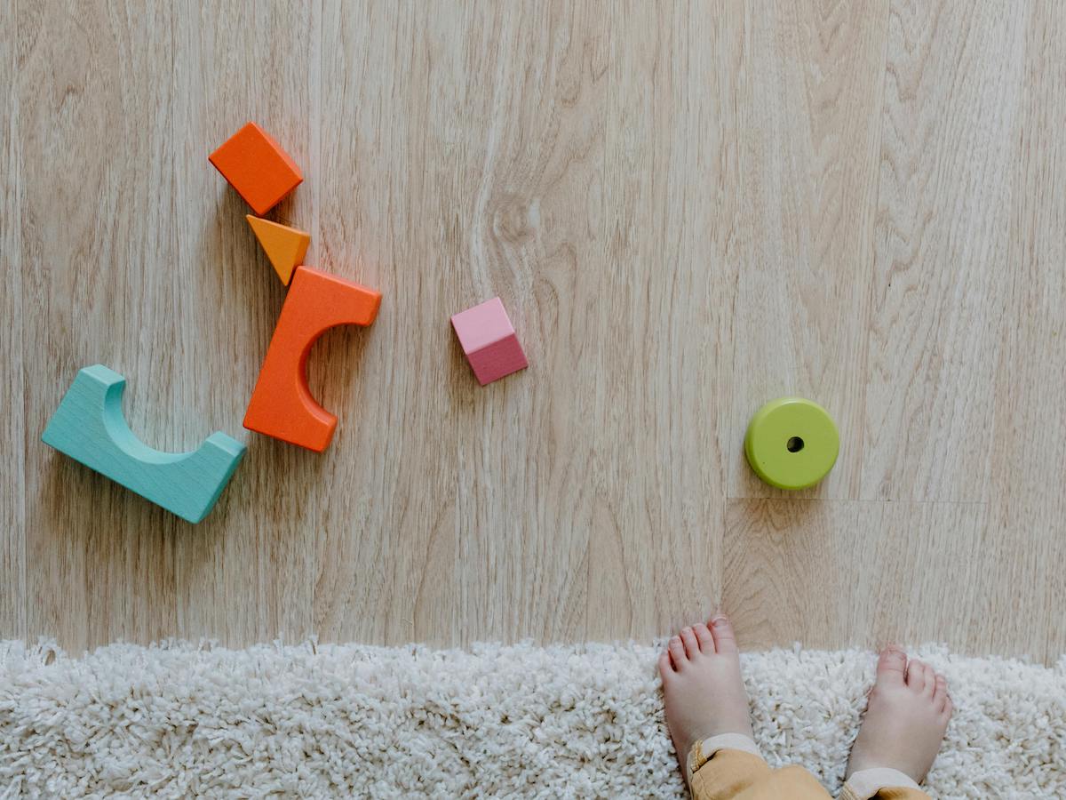 kid friendly space - toddler feet and blocks on a floor